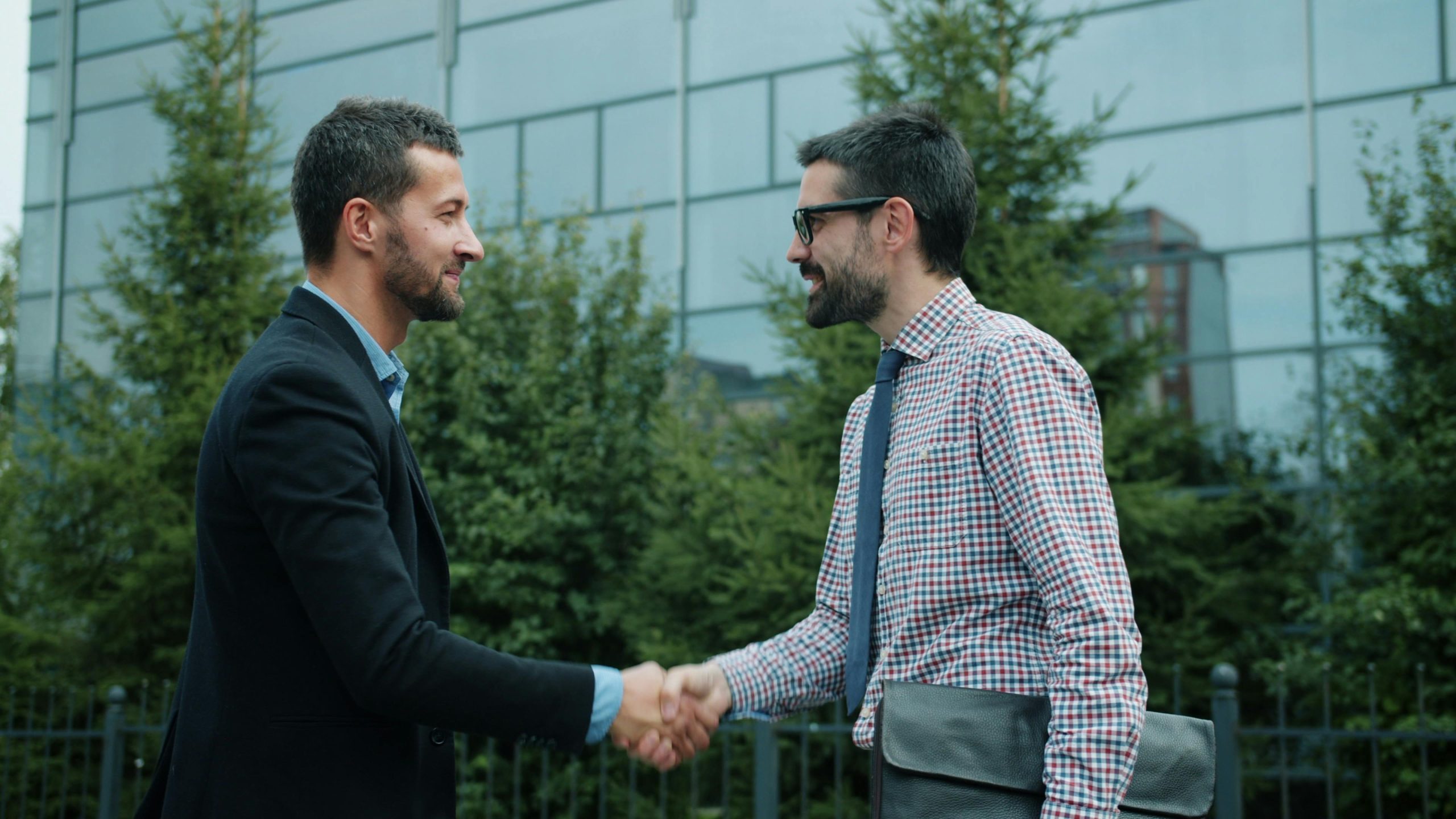 Two professionals discussing business acquisition strategy